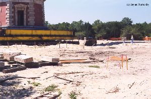 DURING MOVE: Some of the original foundation bricks in the foreground.