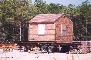 DURING MOVE: The oil house was put on a trailer to be moved.