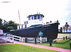 Wooden tugboat at the boatyard exhibit.