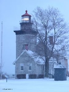 Dusk approaches on a snowy day at the lighthouse.