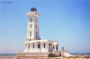 Lighthouse close up with lake in background.