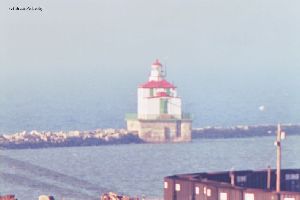 Ashtabula Lighthouse on breakwater with birds.