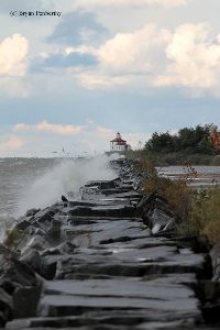 Waves break against the seawall.