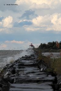Waves crash against the wall.