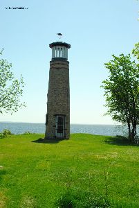 The lighthouse looks out to the lake.