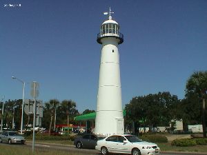 The lighthouse as cars pass by.