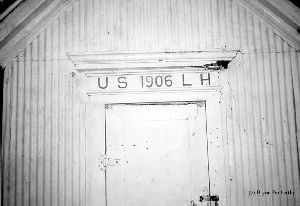 A storage shed bearing the date.