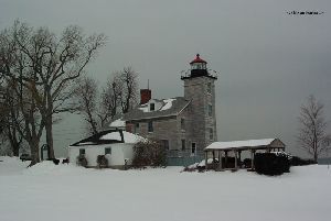 The lighthouse against a gray winter sky.