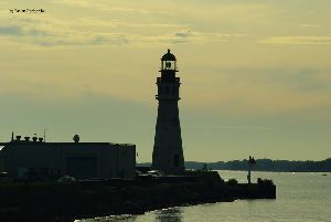 The Buffalo Main Lighthouse is silhouetted against the sky.