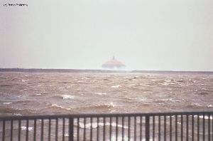 Waves roll over the breakwall in the Buffalo Harbor.