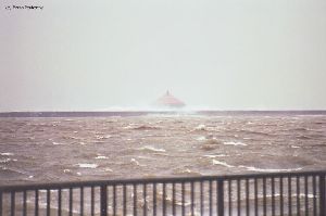 Waves crash over the Buffalo breakwall.