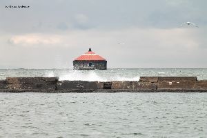 Waves crash against the breakwall by the Buffalo Intake Crib Lighthouse.
