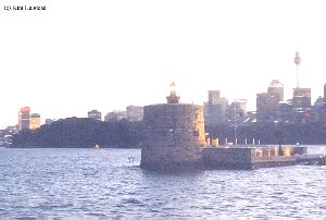 The fort with the lighthouse. Looks like the light is lit.