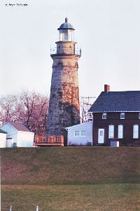 Lighthouse with grass in foreground.
