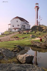 Reflection of the lighthouse in a pond.