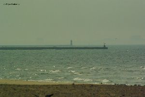 The breakwater lighthouse sits off in the distance.