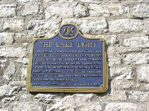 The plaque on the side of the tower.
