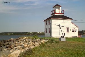 An anchor rests near the lighthouse.