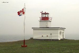 The lighthouse overlooking the ocean.