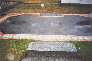 Tile outline shows where an attached work room once stood.