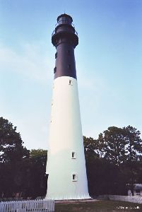 The lighthouse against a blue sky.
