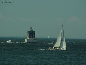 Boats pass by the ledge light.