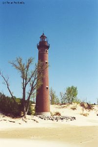 The lighthouse as it stands its post on the beach.