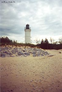 Distance shot of the lighthouse and the rocks.