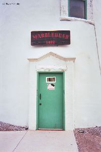 Doorway of lighthouse with sign.