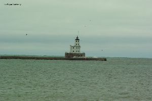 Water breaks over the breakwater.