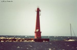 A sailboat goes by the North Pierhead light.