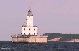 The lighthouse out in the water.
