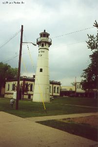Shot of the lighthouse, powerlines are in it.