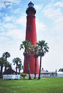 Ponce lighthouse with palm trees in front of it.