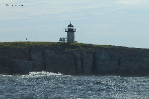 Pond Island Lighthouse upon the cliff.
