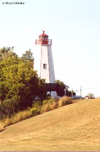 Shot of the lighthouse up on a hill.