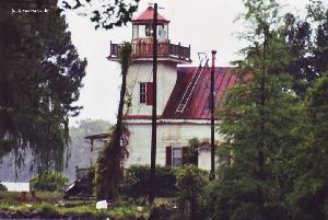 Close up of the lighthouse and the work being done on it.