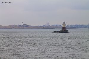 The Robbins Reef Lighthouse with the Port of New York in the background.