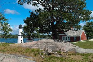 Lighthouse, house, and trees on the island.