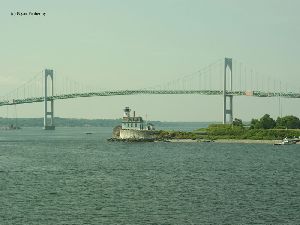 The lighthouse in the shadow of the Newport Bridge.