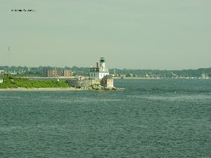 The lighthouse and the harbor in the background.