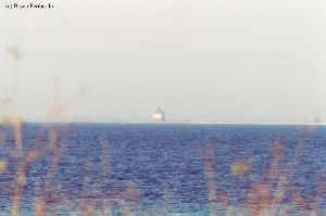 Distant shot of Round Island Lighthouse out in the lake.