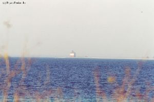Distant shot of Round Island Lighthouse out in the lake.