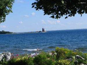 Round Isle Light through trees.