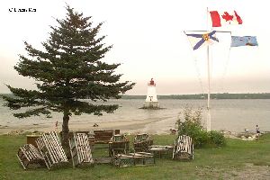 Flags fly by the Sandy Point Lighthouse.