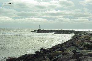 Waves pound the breakwall.