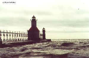 The waves break over the pier.