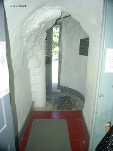 Hallway leading to the stairs and door.