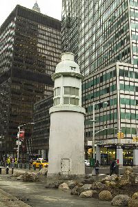 The Titanic Memorial Lighthouse standing along the busy streets of New York.